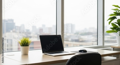 Wallpaper Mural Modern office workspace with laptop, mouse, and city view through a large window Torontodigital.ca