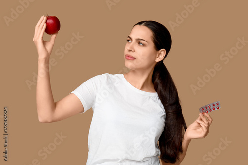 Pretty young woman holding ...