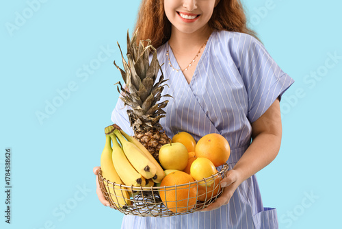 Young woman with basket of ...