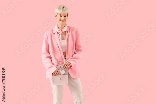Stylish young woman taking ...