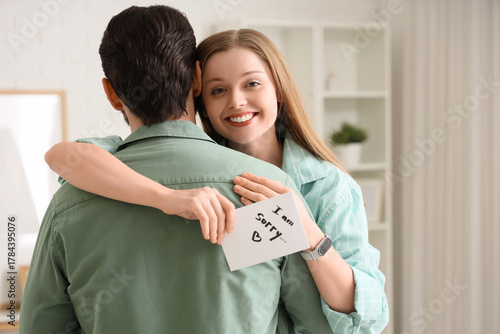 Young woman holding paper w...