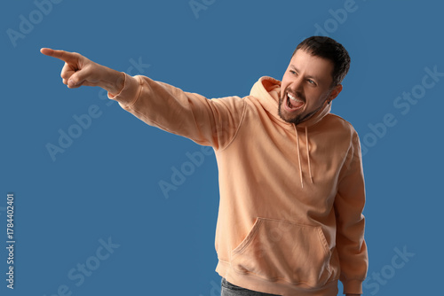 Screaming young man pointin...