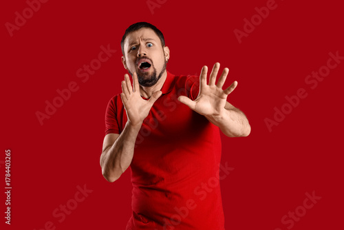 Scared young man on red bac...