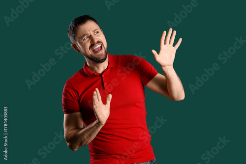Screaming young man on gree...