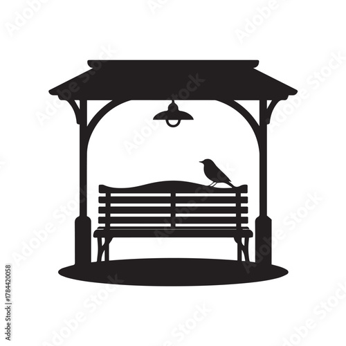 Silhouette of a park gazebo with a bench and a bird