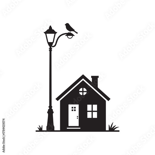 Silhouette of a house with a lamppost and bird