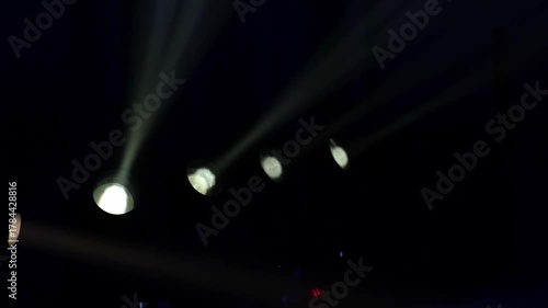 A flashing white strobe light in a dark environment creates an intense and dramatic effect. The light pulses rhythmically, highlighting the contrast between brightness and darkness