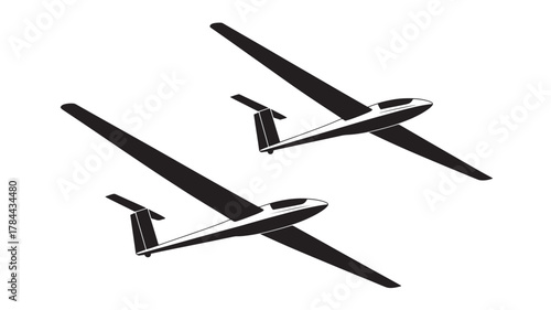 Two glider silhouettes simple vector illustration of soaring aircraft isolated on white background