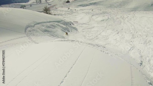 Slow motion footage of a snowboarder triggering a slab avalanche