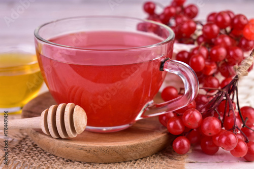 Viburnum berry tea in a transparent cup. Close-up. Medicinal tea for colds.
