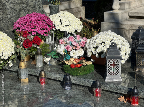 Flowers and candlelits on a tombstone in the public cemetery