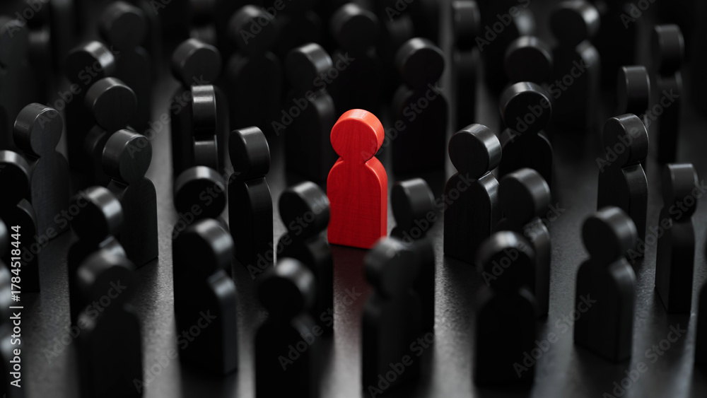 Obraz premium Red Wooden Chess Standing Out Prominently Among Black Chess on Dark Background