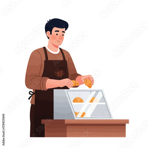 Smiling baker arranging fresh croissants in a display case for customers