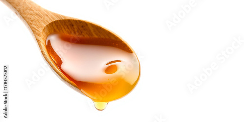 Wooden Spoon Filled with Golden Honey Dripping liquid