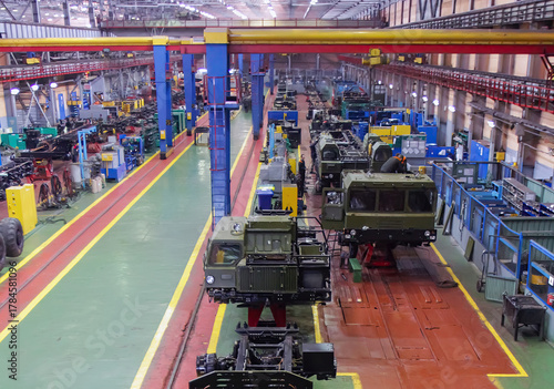 Assembly line in a manufacturing facility showcases vehicle production and engineering efforts during the daytime