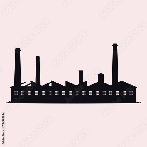 Dark silhouette of a factory building with multiple chimneys and windows against a pale pink background