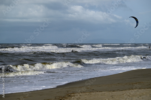 Kitesurfing at italian beach. Some kitesurfers at Torre del Lago beach, tuscany, italy. Some are junping out of the water. Mediterraenean Sea.