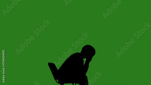 Wallpaper Mural A black silhouette of a man sits on a chair and thinks about something against a green chroma key background. Minimalist contrast and modern visual composition, mockup. Torontodigital.ca