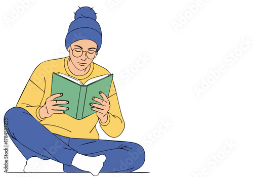 A young adult reads a book outdoors, wearing a beanie and glasses. Relaxed pose, focused on the text.  Warm, inviting scene. Book Soul Inspire.