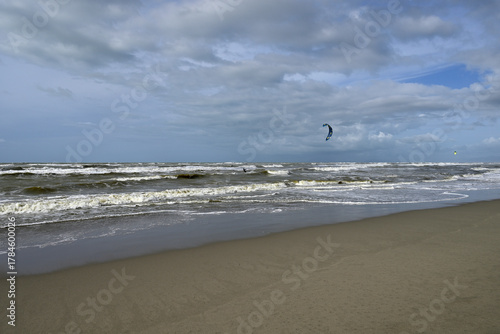 Kitesurfing at italian beach. Some kitesurfers at Torre del Lago beach, tuscany, italy. Some are junping out of the water. Mediterraenean Sea.