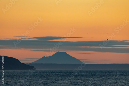 Chirip volcano at sunset, view from the sea. Iturup Island. South Kurils