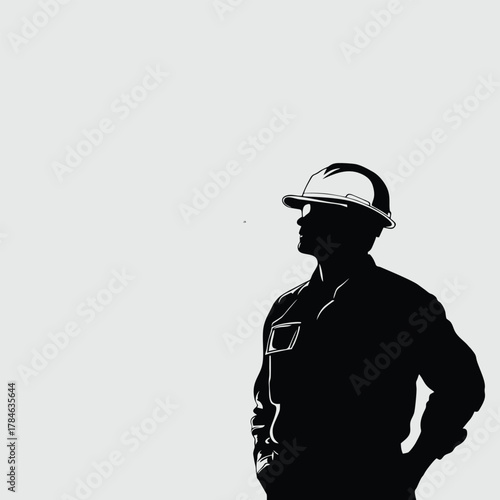 Silhouette of a construction worker wearing a hard hat and work clothes, looking to the side.