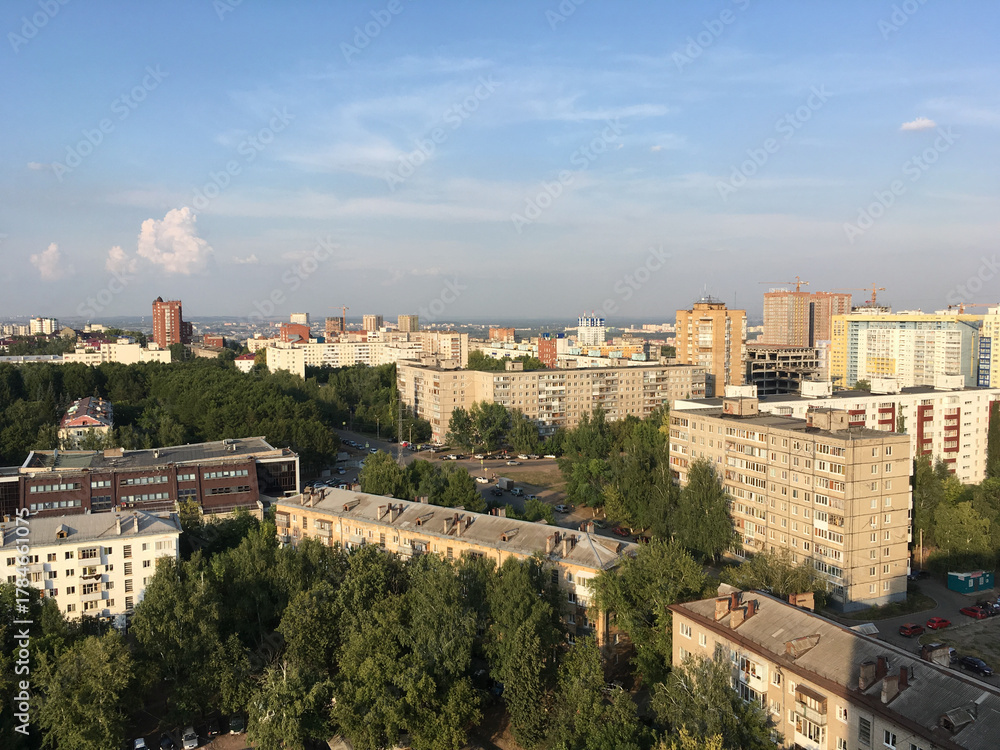 Obraz premium Aerial view of Ufa city with residential buildings and green trees. Urban development, environment, and modern Russian architecture.