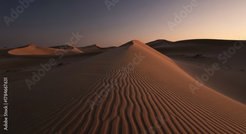 Fototapeta Naklejka Na Ścianę i Meble -  Sweeping sand dunes under soft twilight, textured with wind ripples, brown hues