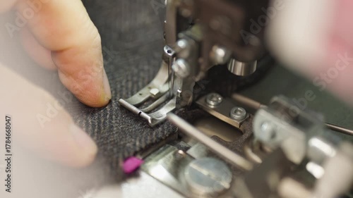 Industrial Sewing Machine in Action. Close-up Textile Factory Footage