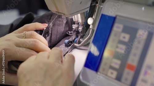 Industrial Sewing Machine in Action. Close-up Textile Factory Footage