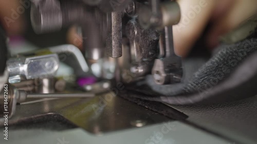Industrial Sewing Machine in Action. Close-up Textile Factory Footage