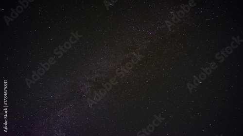 Timelapse of starry night sky showing the Milky Way moving slowly across dark space above Earth