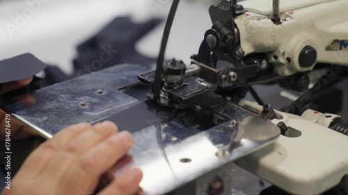 Industrial Sewing Machine in Action. Close-up Textile Factory Footage