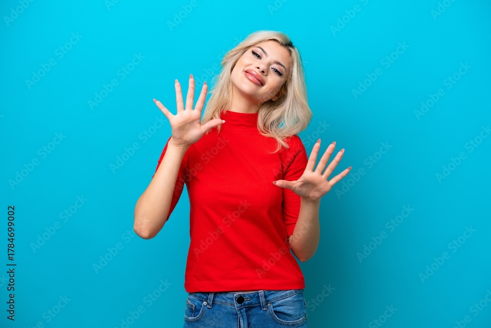 Fototapeta premium Young Russian woman isolated on blue background counting ten with fingers