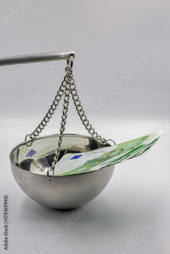 Money on balance scale symbolizing financial value.