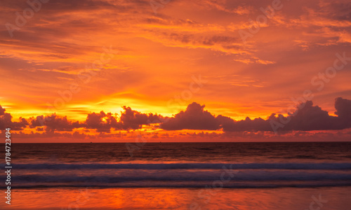 Stunning orange sunset sky over calm ocean waves with golden light reflections. Ideal for travel themes, tropical landscapes, peaceful backgrounds, meditation, or beach resort branding.