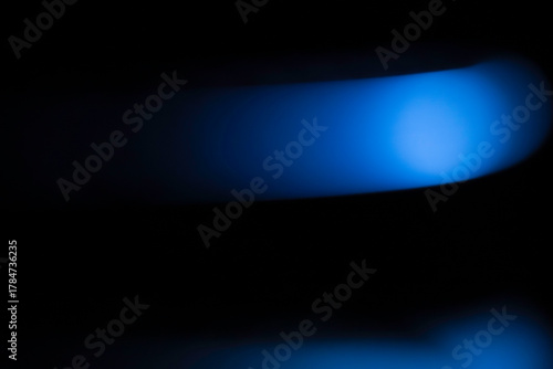 Blue electric light in a dark background. Gradient abstract minimal stroke light. 8K Resolution.