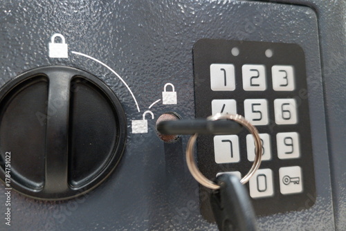 Secure storage safe with keypad and key slot positioned in a room, showcasing a focus on safety measures during organization