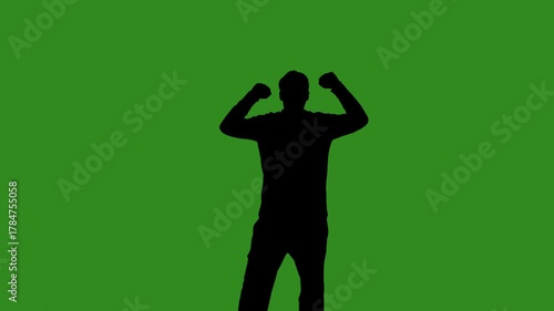 A black silhouette of a male fan cheerfully celebrates victory against a green chroma key background. Minimalist contrast and modern visual composition, mockup.