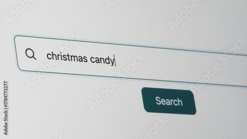 Christmas Candy Search on Search Engine. Close Up Shot of Typing Search Term in Search Box on Web Page on Computer Screen. Real Time 4K.