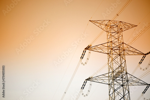 Dramatic power lines against warm gradient sky for infrastructure projects