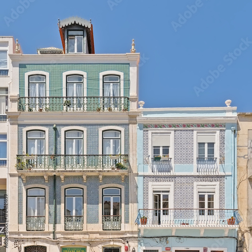  Facades of traditional portuguese houses decorated with azulejos tiles in Lisbon, Portugal 