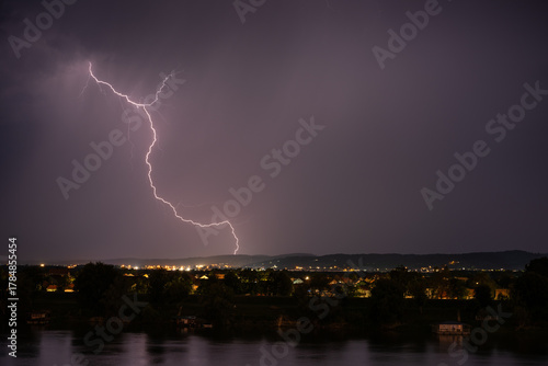 Beautiful lightning during thunderstorm at night, over hills near croatian city of Slavonski Brod