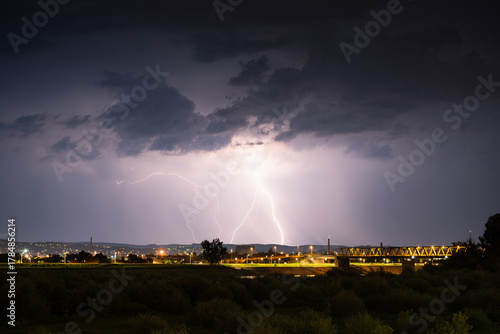 Multiple lightning during thunderstorm at night, over hills near croatian city of Slavonski Brod