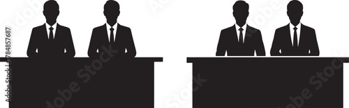 Four business people sitting at desks silhouette