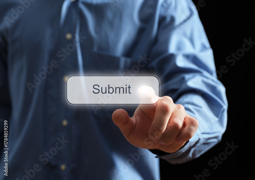 Hand touching virtual submit button on screen
