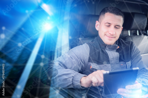 Logistics driver uses a digital tablet to manage deliveries and track transport routes, improving efficiency in smart fleet operations.