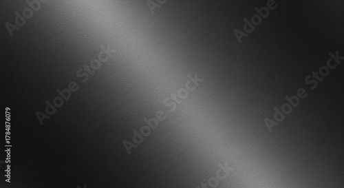 Abstract dark brushed metal texture with diagonal light reflection