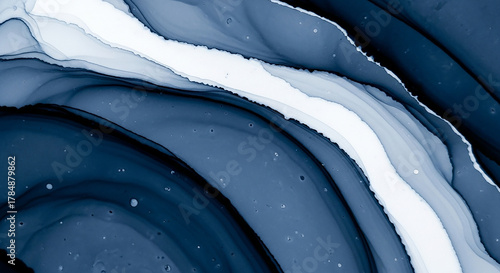 Abstract flowing ink art with deep blues and white swirls