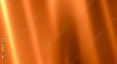 Abstract flowing orange fabric texture with light reflections